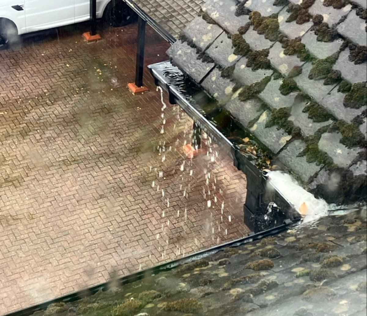Overflowing gutter at a managed residential property